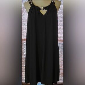 Embellished black sleeveless evening swing dress.